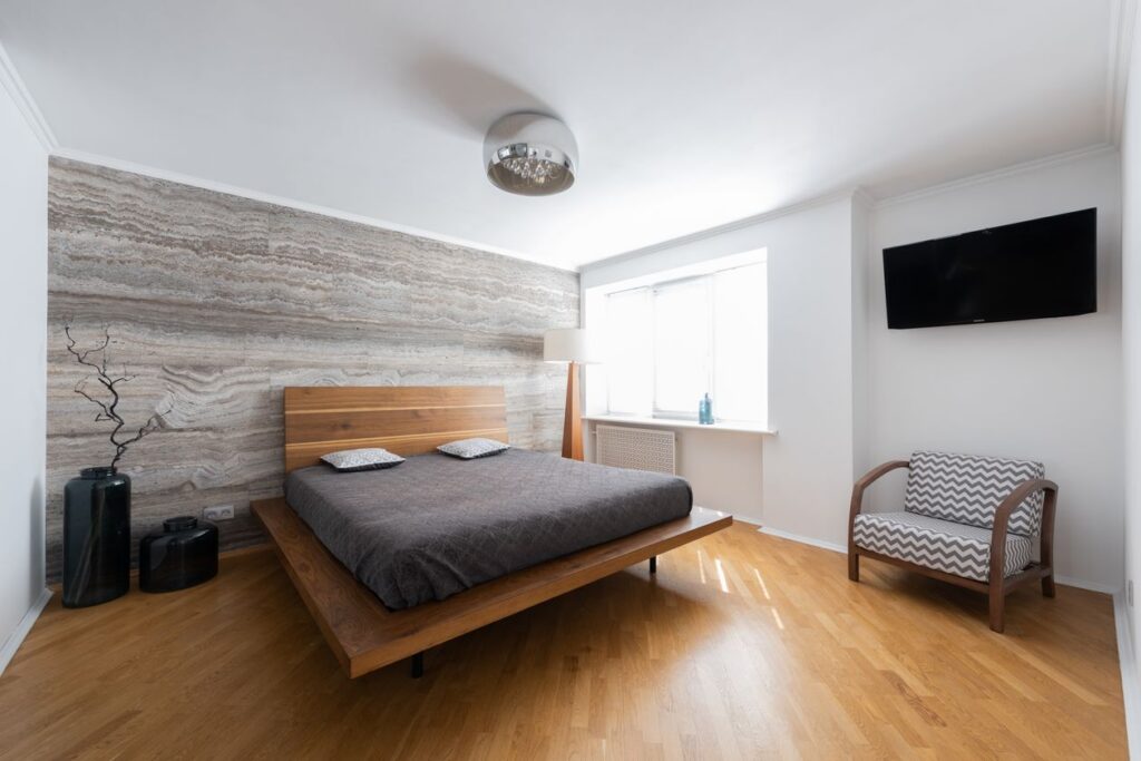Luxury bedroom interior design with armchair seating area