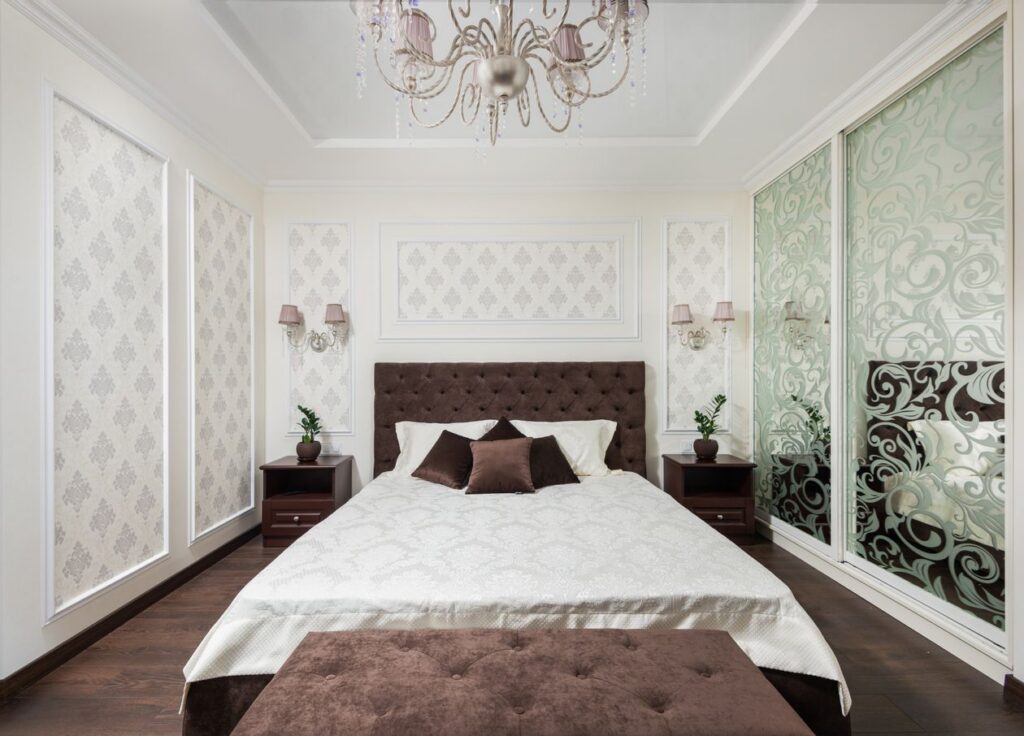 Luxury bedroom interior design with chandelier and plush bedding