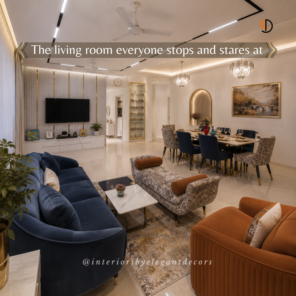 Open living dining with navy sofa, rust armchair and dining table by Elegant Decors