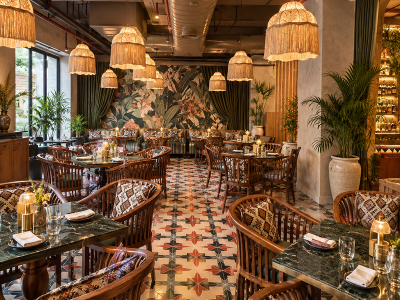Restaurant bar with coffered wood ceiling, bottle wall and quilted chairs by Elegant Decors