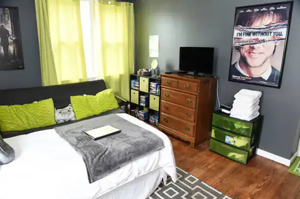 Cozy bedroom with lime green accents and organization closet.